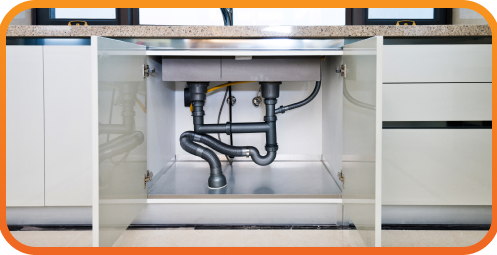 shot of pipes under a kitchen sink