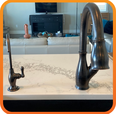 plumbing fixtures installed on granite countertop